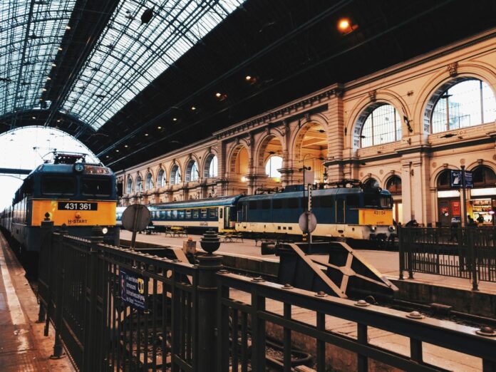 two black-and-yellow trains on train station