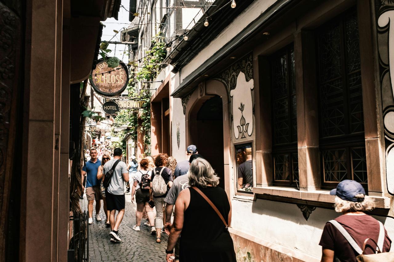 People walking through a narrow, historic european street.